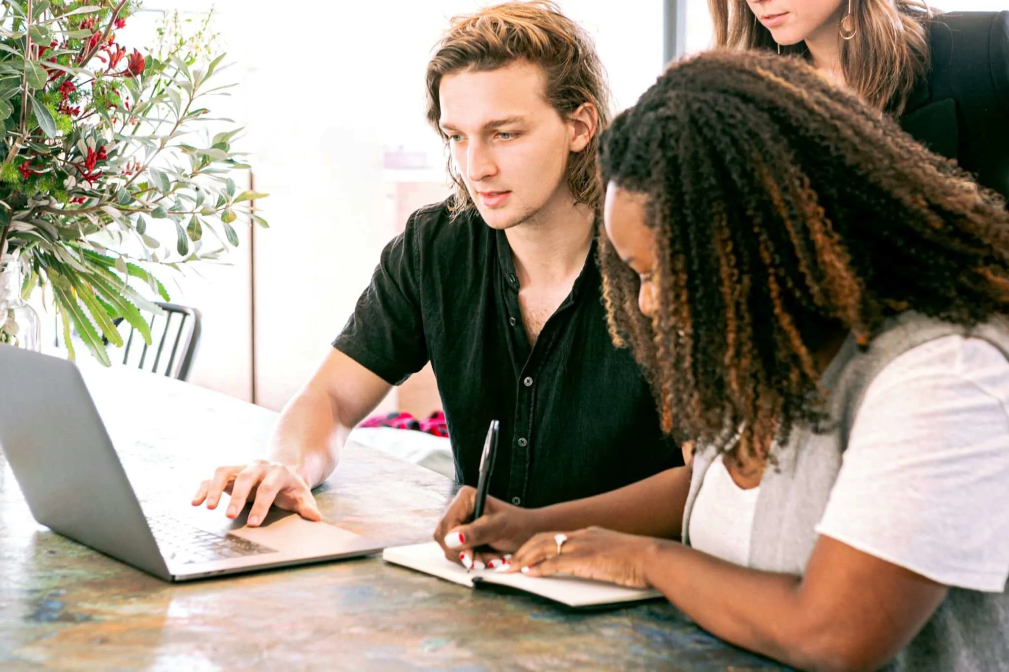 man and woman working in front of laptop